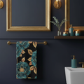Beautiful dark cozy bathroom with teal and gold floral towel on gold bar with brass mirror and candles