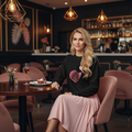 Black sweatshirt in upscale restaurant with pink skirt