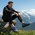 Man sitting cliff edge crystal sneakers mountain view