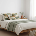 Peaceful bedroom with layered Botanical Fan pillows