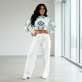 Slender woman with long dark hair mint geometric crop top white pants modern interior