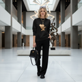 Stylish woman in black eagle cityscape sweatshirt at modern art museum - elevated casual American luxury fashion
