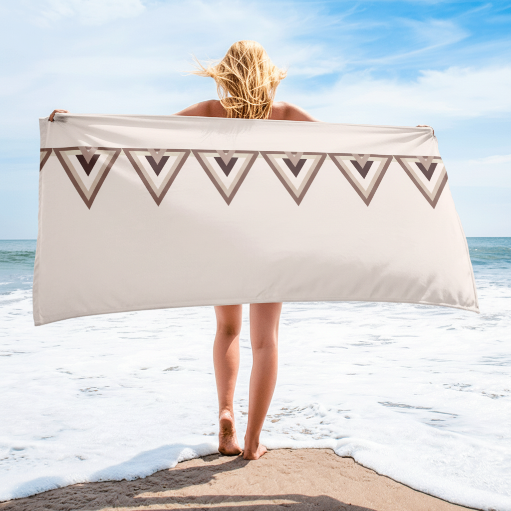 Woman holding beige geometric triangle beach towel on coastal beach