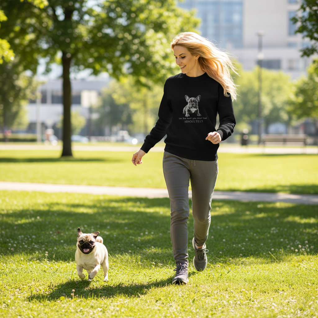 Woman in black sweatshirt running with pug in urban park