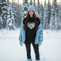 Woman in black sweatshirt with light blue winter accessories