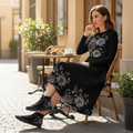 Woman in floral dress and sneakers at cafe terrace