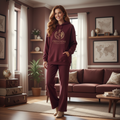 Woman in maroon Freedom Travel hoodie with globe design