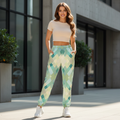 Women's turquoise geometric track pants with cream beige fitted top white sneakers luxury urban lifestyle athleisure
